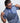 Man wearing the Frenzy athletic golf polo by Ferret, with bold geometric line pattern in multiple directions and lightweight fabric. Golf polo