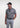Man wearing the Frenzy athletic golf polo by Ferret, with bold geometric line pattern in multiple directions and lightweight fabric. Golf polo