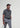Man wearing the Frenzy athletic golf polo by Ferret, with bold geometric line pattern in multiple directions and lightweight fabric. Golf polo