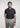 Man wearing the Square F performance polo by Ferret, featuring hidden placket and geometric F pattern for a refined golf look. Minimal design golf polo. Quality golf