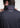 Man wearing the Square F performance polo by Ferret, featuring hidden placket and geometric F pattern for a refined golf look. Minimal design golf polo. Quality golf
